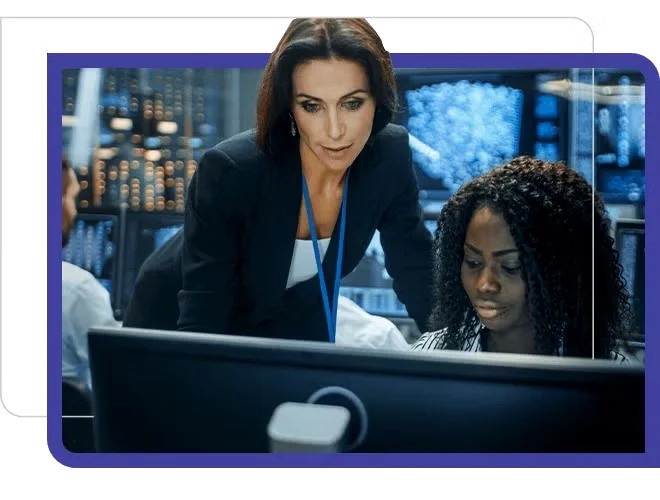 security compliance, two women in dark computer room looking at screens